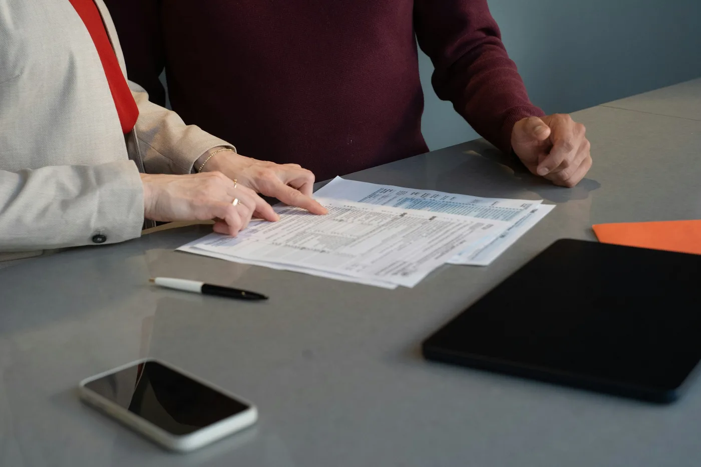 Two people reviewing the same document together